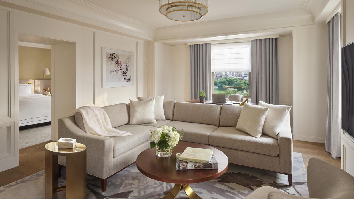 sectional sofa sits in spacious living room with bedroom visible through door