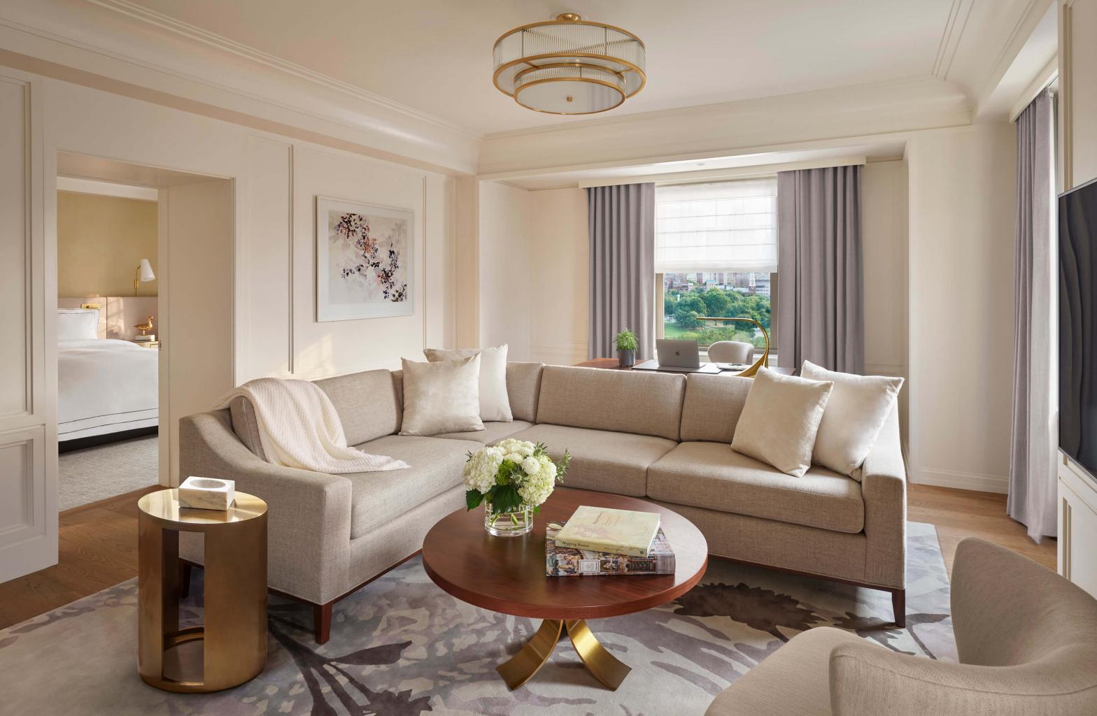 view of living room with arm chair, sectional sofa, and circular wooden coffee table