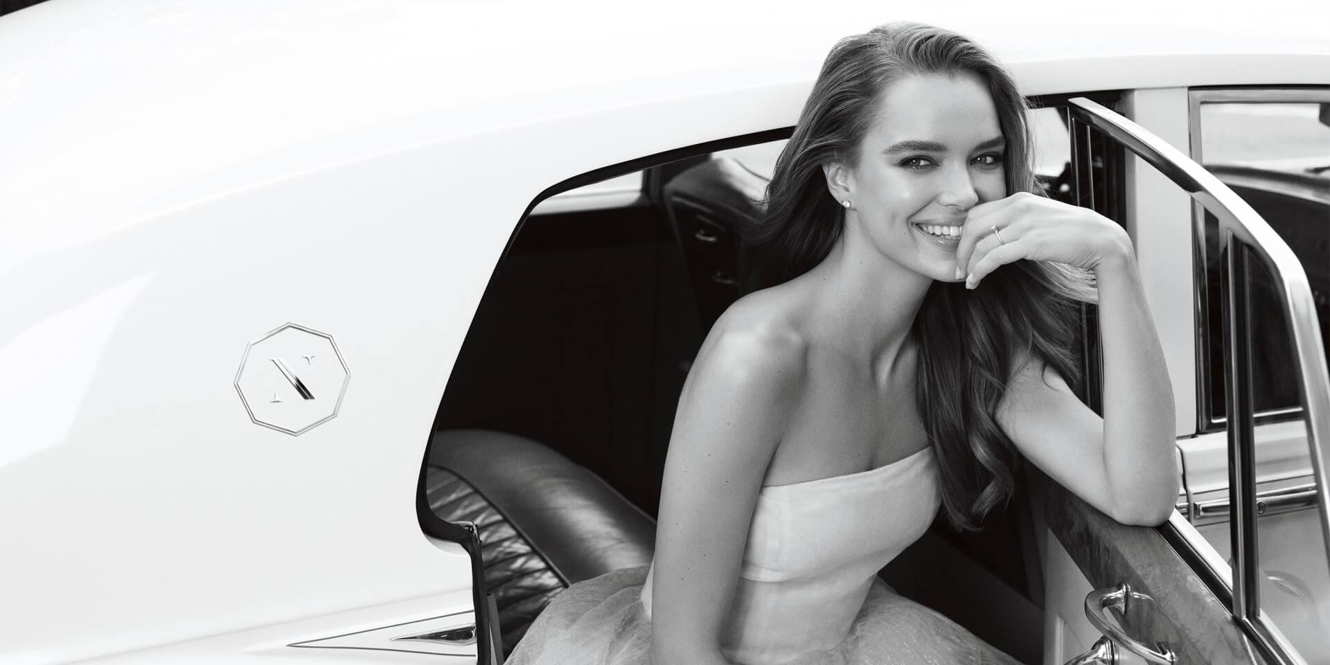 Black and white image of a Bride in car