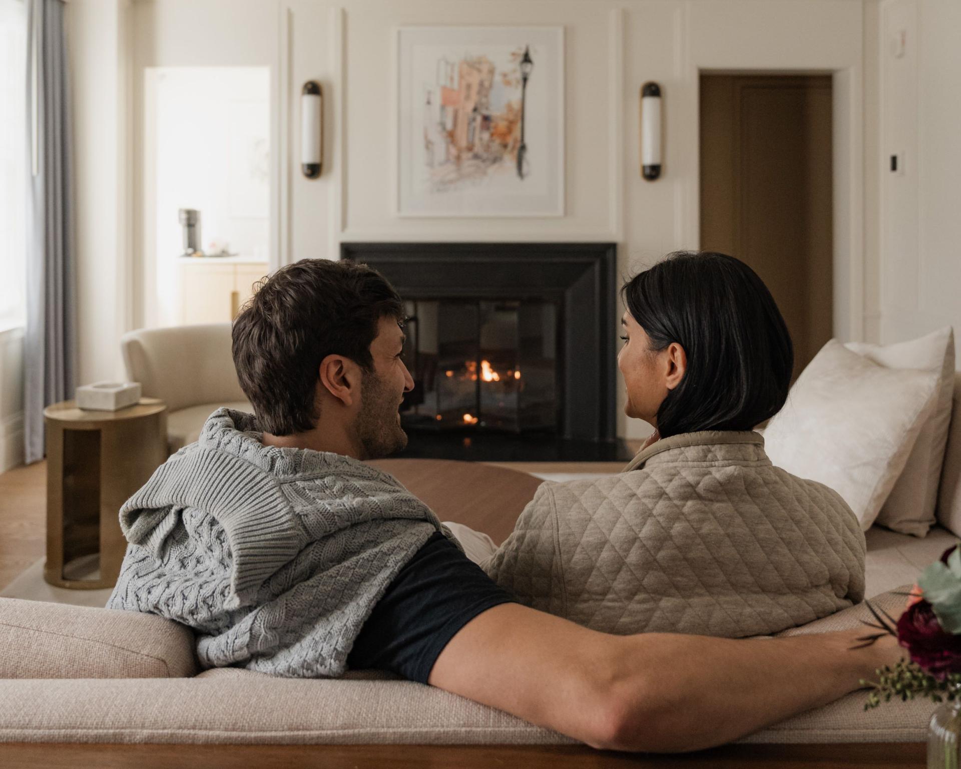 Couple in a fireplace suite at The Newbury Boston