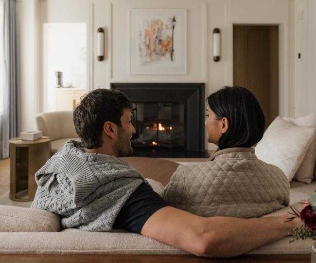 Couple in a fireplace suite at The Newbury Boston