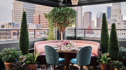 Two plush chairs at a dining table at The Contessa restaurant in The Newbury Boston