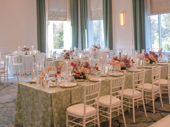 Wedding banquet table with a variety of colorful floral arrangements